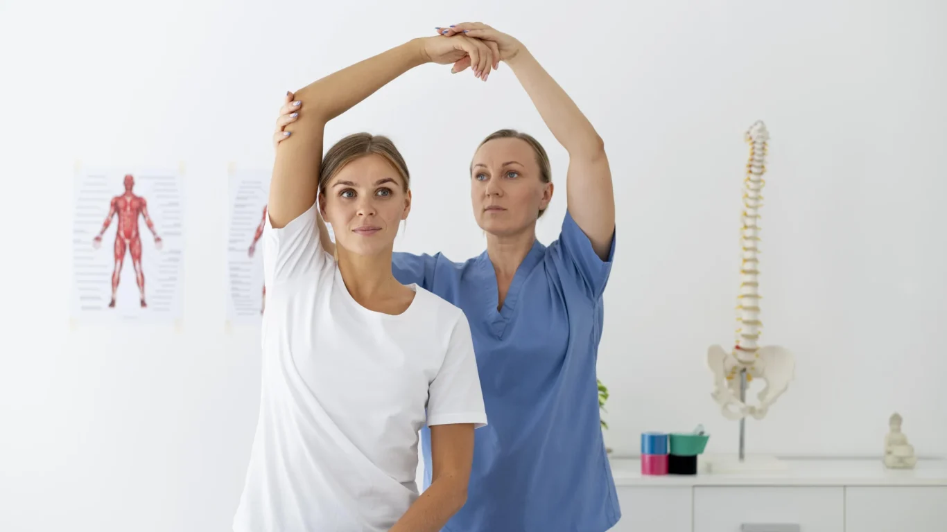 physiotherapist-helping-female-patient-her-clinic (1)
